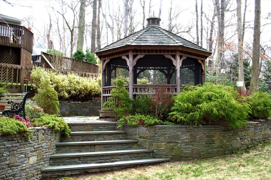 beautiful backyard deck with stone steps and gazebo